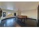 Spacious game room features a billiards table, wood floors, modern light fixture, and neutral walls at 7520 Jacaranda Bay St, Las Vegas, NV 89139