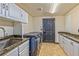 Functional laundry room features sink, counter space, cabinets and modern washer and dryer at 7520 Jacaranda Bay St, Las Vegas, NV 89139