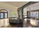 Open living room features stone accents, hardwood floors, and an arched entry at 7520 Jacaranda Bay St, Las Vegas, NV 89139