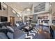 Bright living room features a fireplace, dark wood floors, and flows into the kitchen at 7520 Jacaranda Bay St, Las Vegas, NV 89139