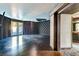 Spacious living room featuring hardwood floors, textured wallpaper, and direct access to the outdoor pool at 7520 Jacaranda Bay St, Las Vegas, NV 89139