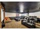 Home media room features plush theater seating and a ceiling painted black at 7520 Jacaranda Bay St, Las Vegas, NV 89139