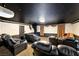 Home theater room with tiered seating, a projector screen, and comfortable leather recliners for the ultimate movie experience at 7520 Jacaranda Bay St, Las Vegas, NV 89139