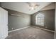 Gray bedroom featuring a vaulted ceiling, a window, and neutral carpeting at 7620 Whispering River St, Las Vegas, NV 89131