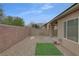 Backyard with gravel, brick landscaping, rock feature, and low maintenance at 7705 Lily Trotter St, North Las Vegas, NV 89084