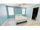 Inviting bedroom with wood floors, bright paint, and natural light at 836 Sheerwater Ave, Henderson, NV 89052
