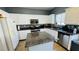 Functional kitchen boasting granite countertops, white cabinetry, stainless steel appliances and a center island at 836 Sheerwater Ave, Henderson, NV 89052