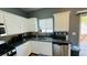 Functional kitchen boasting granite countertops, white cabinetry, stainless steel appliances and lots of natural light at 836 Sheerwater Ave, Henderson, NV 89052