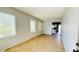 Open-concept living room with tile flooring, lots of natural light and archway to kitchen at 836 Sheerwater Ave, Henderson, NV 89052