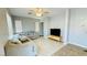 Comfortable living room features ceramic tile floors, neutral decor, ceiling fan and a sectional sofa at 836 Sheerwater Ave, Henderson, NV 89052