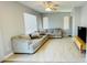 Comfortable living room features ceramic tile floors, neutral decor, ceiling fan and a sectional sofa at 836 Sheerwater Ave, Henderson, NV 89052