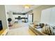 Open-concept living room features a modern kitchen and adjacent tile flooring for easy maintenance at 836 Sheerwater Ave, Henderson, NV 89052