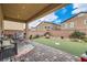 Charming backyard with patio and artificial grass, great for outdoor relaxation and entertaining at 92 Tesla Ridge Way, Las Vegas, NV 89183