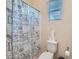 Cozy bathroom features a white toilet and a themed shower curtain with coastal sea life at 92 Tesla Ridge Way, Las Vegas, NV 89183