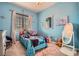 A bedroom with blue walls features a closet and ample natural light at 92 Tesla Ridge Way, Las Vegas, NV 89183