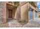 Inviting entryway with a brick path leading to a red door and attached two-car garage at 92 Tesla Ridge Way, Las Vegas, NV 89183