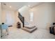 Bright entryway featuring tile floors, staircase with dark railing, and natural light at 92 Tesla Ridge Way, Las Vegas, NV 89183