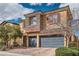 Inviting two-story home with brick driveway, attached two-car garage and landscaped front yard at 92 Tesla Ridge Way, Las Vegas, NV 89183