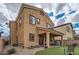 Back exterior elevation of home showcases the yard, patio, and architectural style at 92 Tesla Ridge Way, Las Vegas, NV 89183