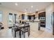 Modern kitchen with dark cabinetry, stainless steel appliances, and an adjacent dining area at 92 Tesla Ridge Way, Las Vegas, NV 89183