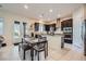 Modern kitchen with dark wood cabinets, stainless steel appliances, granite countertops and open access to patio at 92 Tesla Ridge Way, Las Vegas, NV 89183