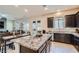 A spacious kitchen features granite countertops, stainless steel appliances, and a large center island at 92 Tesla Ridge Way, Las Vegas, NV 89183