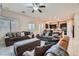 Spacious living room with tile flooring, large windows, comfortable sofas and an open floor plan at 92 Tesla Ridge Way, Las Vegas, NV 89183