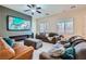 Cozy living room featuring a modern fireplace, large screen TV, comfortable couches and neutral decor at 92 Tesla Ridge Way, Las Vegas, NV 89183