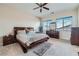 A cozy main bedroom with neutral walls and carpet features a ceiling fan and ample natural light at 92 Tesla Ridge Way, Las Vegas, NV 89183