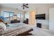 A carpeted main bedroom boasts a ceiling fan, natural light, and an en-suite bathroom at 92 Tesla Ridge Way, Las Vegas, NV 89183