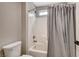 Bathroom featuring a shower/tub combo with white subway tile, gray curtain, and toilet at 9292 Vervain Ct, Las Vegas, NV 89149
