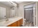 Bathroom with wood flooring, single sink vanity, and a shower/tub combo at 9292 Vervain Ct, Las Vegas, NV 89149
