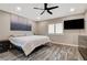 A spacious bedroom featuring a ceiling fan, TV, and decorative artwork above the bed at 9292 Vervain Ct, Las Vegas, NV 89149