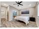 Comfortable bedroom with a ceiling fan and a doorway to the bathroom suite at 9292 Vervain Ct, Las Vegas, NV 89149