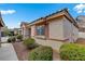 Side view of a single-story home with a tiled roof, manicured landscaping, and a sidewalk at 9292 Vervain Ct, Las Vegas, NV 89149