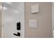 Front door with smart lock, keypad, and light switches installed on the wall at 9292 Vervain Ct, Las Vegas, NV 89149