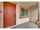 Inviting front entrance with a solid door, exterior lighting, and a textured wall finish at 9292 Vervain Ct, Las Vegas, NV 89149