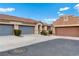 Exterior view of attached garages with well-maintained landscaping at 9292 Vervain Ct, Las Vegas, NV 89149
