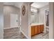 Hallway with wood flooring leads to bathroom with vanity at 9292 Vervain Ct, Las Vegas, NV 89149