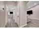 Hallway featuring wood-look floors and crisp white doors leading into other rooms of the house at 9292 Vervain Ct, Las Vegas, NV 89149