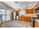 Bright kitchen featuring stainless steel appliances, wood cabinets, and sliding glass doors to the patio at 9292 Vervain Ct, Las Vegas, NV 89149