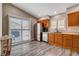 Well-lit kitchen with stainless steel appliances, wood-grain flooring, and a breakfast nook area at 9292 Vervain Ct, Las Vegas, NV 89149