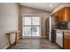 A kitchen area with wood cabinets and a stainless steel refrigerator, and a sliding glass door to the back patio at 9292 Vervain Ct, Las Vegas, NV 89149