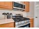 Stainless steel gas range oven with a matching microwave and ample counter space in the kitchen at 9292 Vervain Ct, Las Vegas, NV 89149
