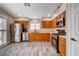 Spacious kitchen showcasing stainless steel appliances, wood cabinetry, and sleek flooring at 9292 Vervain Ct, Las Vegas, NV 89149