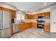 Bright kitchen featuring wood cabinets, stainless steel appliances, and a modern design at 9292 Vervain Ct, Las Vegas, NV 89149