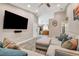Inviting living room with a large sectional couch, open layout, and a glimpse into the kitchen at 9292 Vervain Ct, Las Vegas, NV 89149