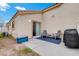 Inviting patio area with seating, grill, and sliding door access to the home at 9292 Vervain Ct, Las Vegas, NV 89149