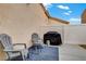 Relaxing outdoor patio area with comfortable seating and covered grill, great for entertaining at 9292 Vervain Ct, Las Vegas, NV 89149