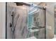 Walk-in shower features a large rain shower head, handheld sprayer, and decorative accent wall at 9292 Vervain Ct, Las Vegas, NV 89149
